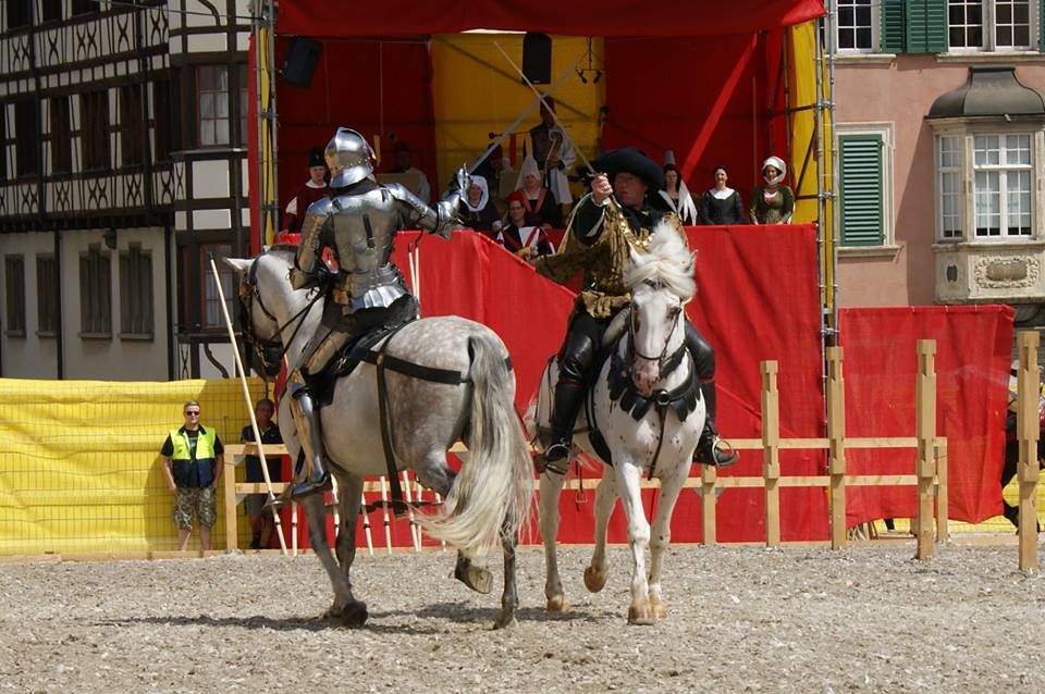 Wolfgang Krischke takes a break from judging to participate in a mounted duel with Arne Koets. You can see members of the Court in the stands behind them. (photo by Ingrid Isabella von Altdorf)