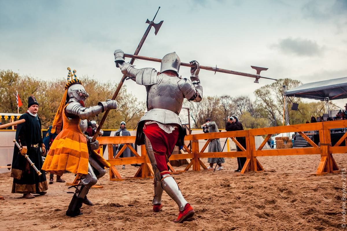 Knight Marshal Sergey Vislenev closely watches the poleaxe fight between Sergey Zhuravlev(left) and Viktor Ruchkin(right) at the Tournament of St. George in Moscow, Russia(photo by Andrew Boykov/Ratobor Show)