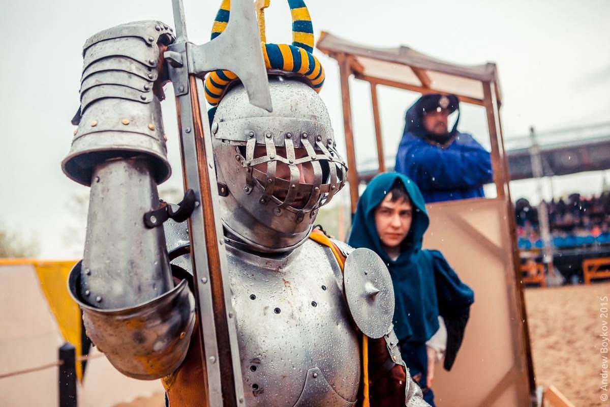 Sergey Zhuravlev's visor is dented. Possibly by a blow from a poleaxe, like the one he is holding. Tournament of St. George 2015, Moscow, Russia(photo by Andrew Boykov/Ratobor Show)